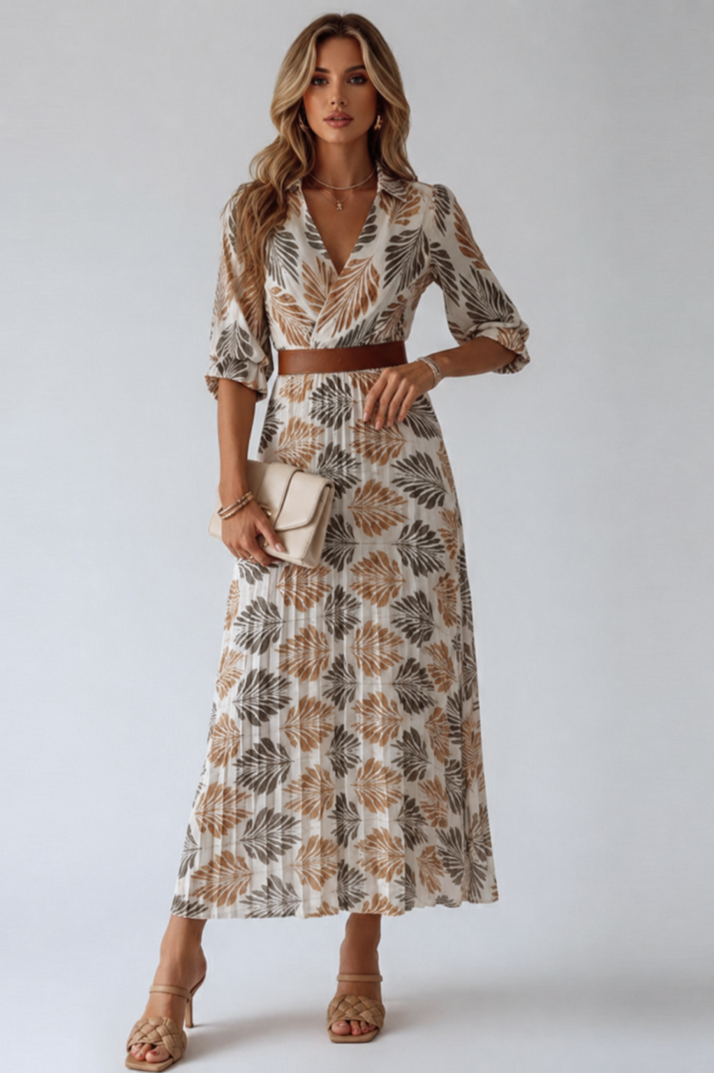 Woman wearing a patterned dress with a belt on a white background