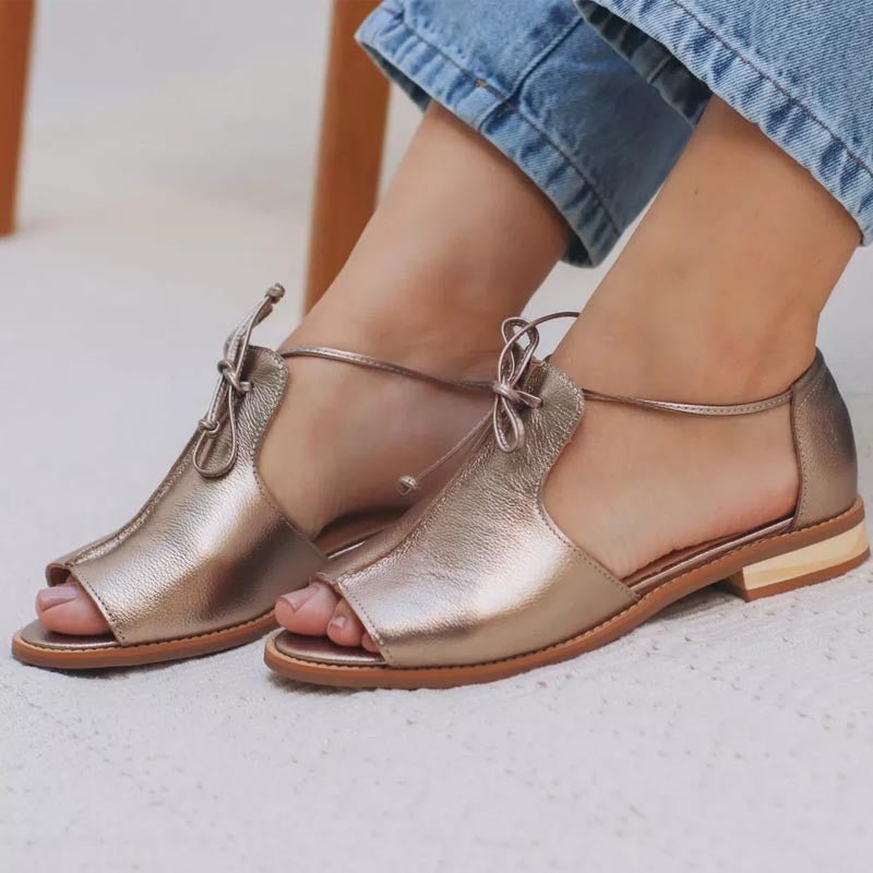 Women's silver metallic flat sandals with bow tie straps and open toe