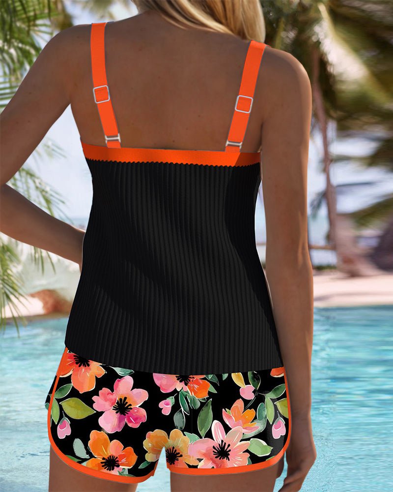 Women's orange tummy control tankini set with floral print shorts