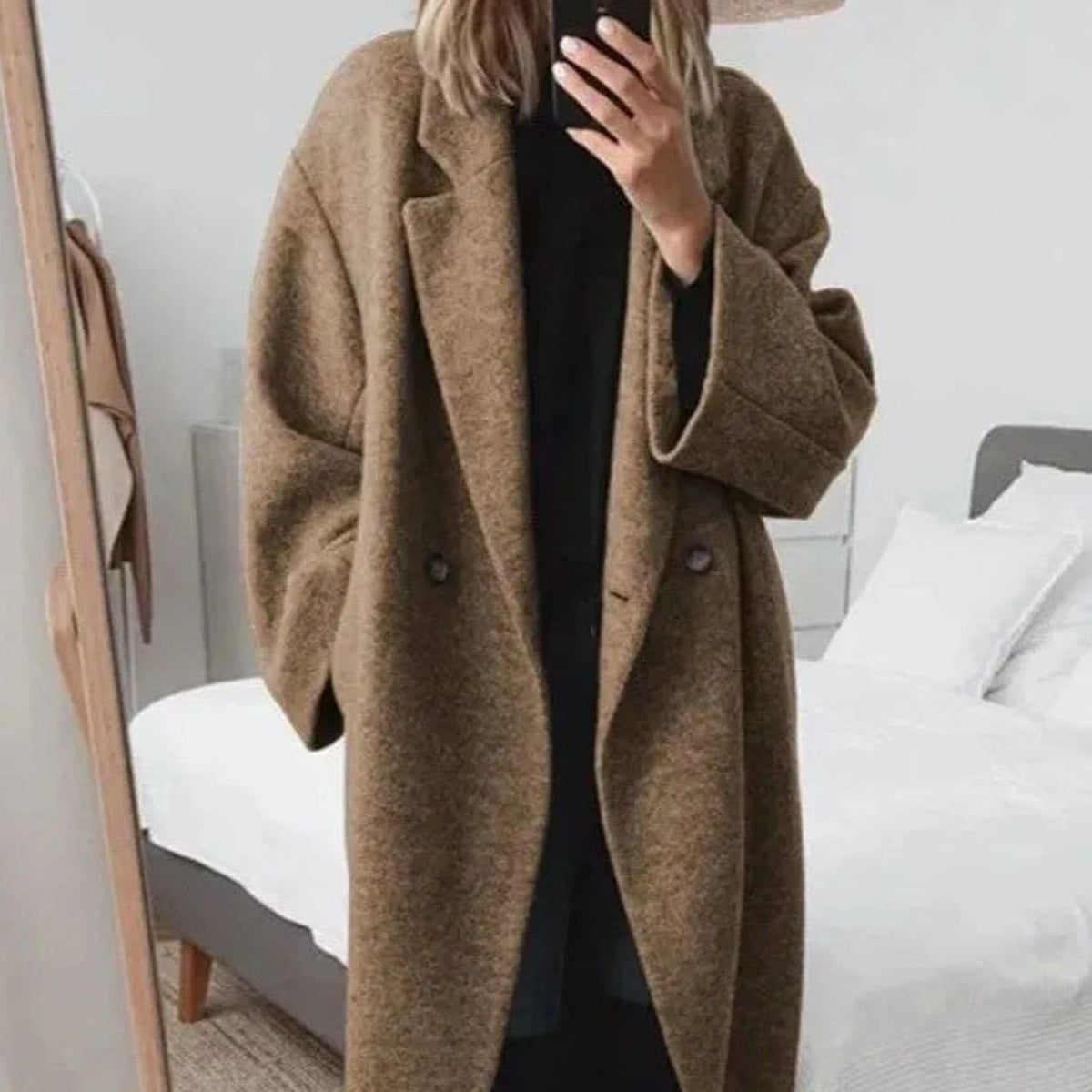 Oversized double-breasted longline coat in brown, featuring a notched lapel and button front.