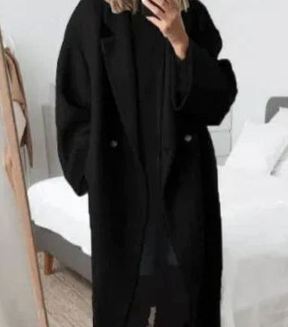 Oversized double-breasted longline coat in black, featuring a notched lapel and button front.