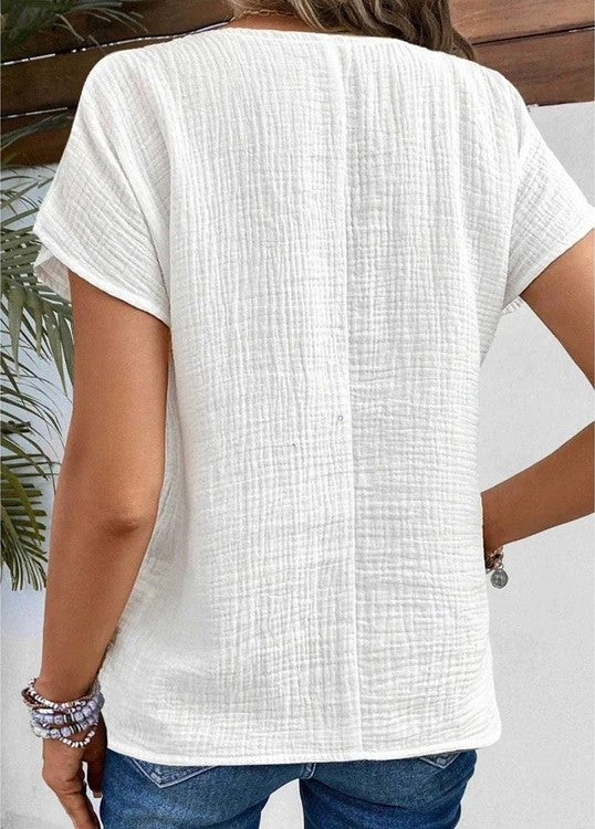 Women's white collared button-up blouse in textured fabric