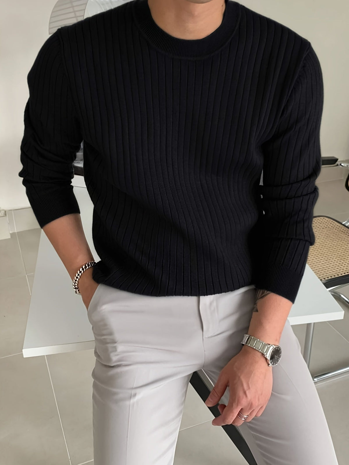 Black Crew Neck Jumper worn with dark trousers, front view