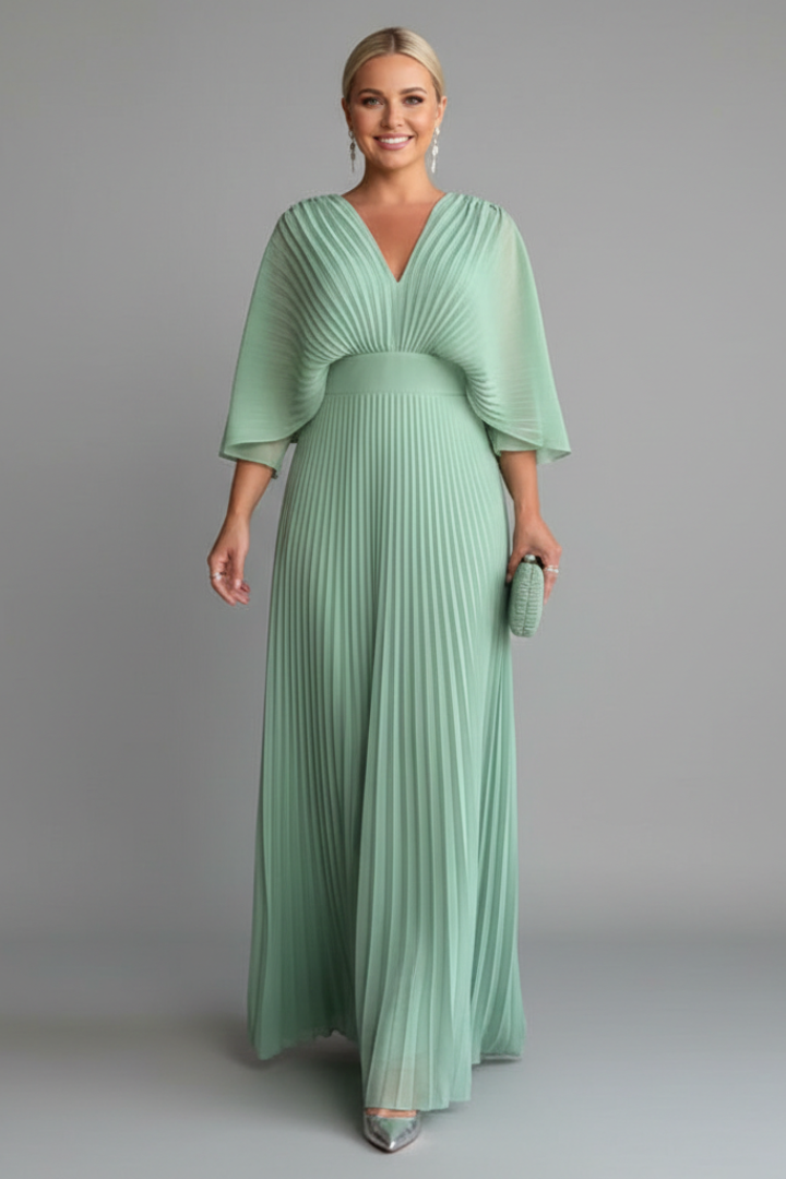 Women's yellow long sleeve maxi dress with pleated skirt and wrap front