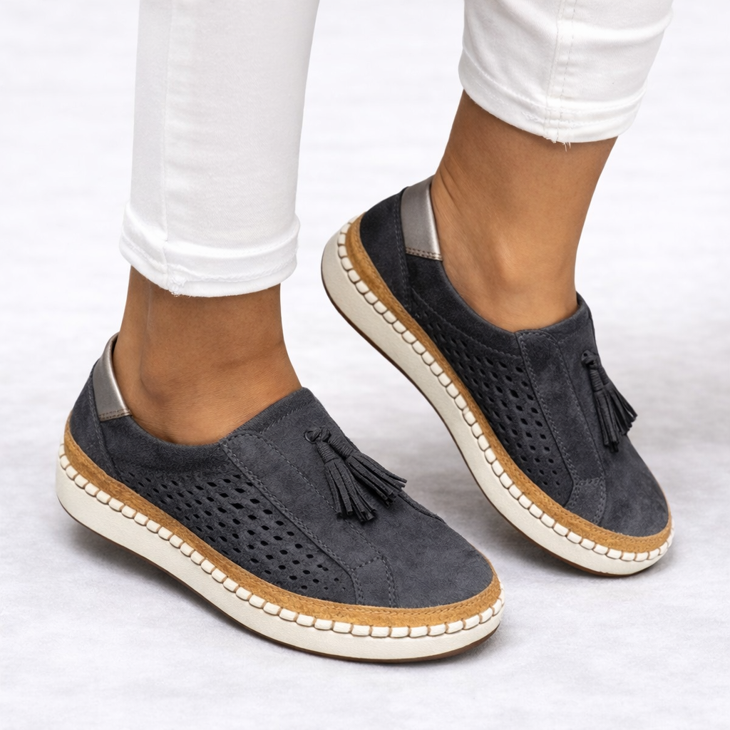 Women's green slip-on tassel loafers with perforated panels