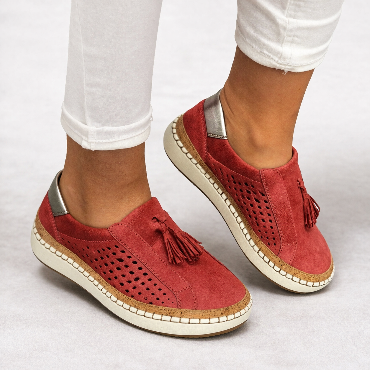 Women's green slip-on tassel loafers with perforated panels