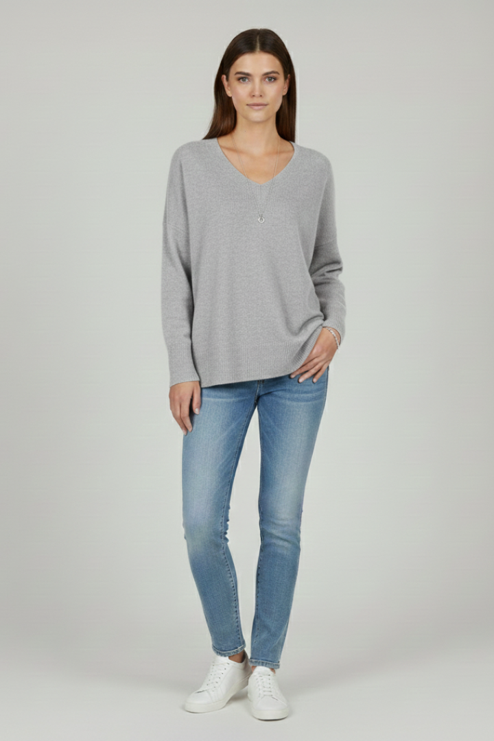 Women's white V-neck jumper with dropped shoulders and a straight hem