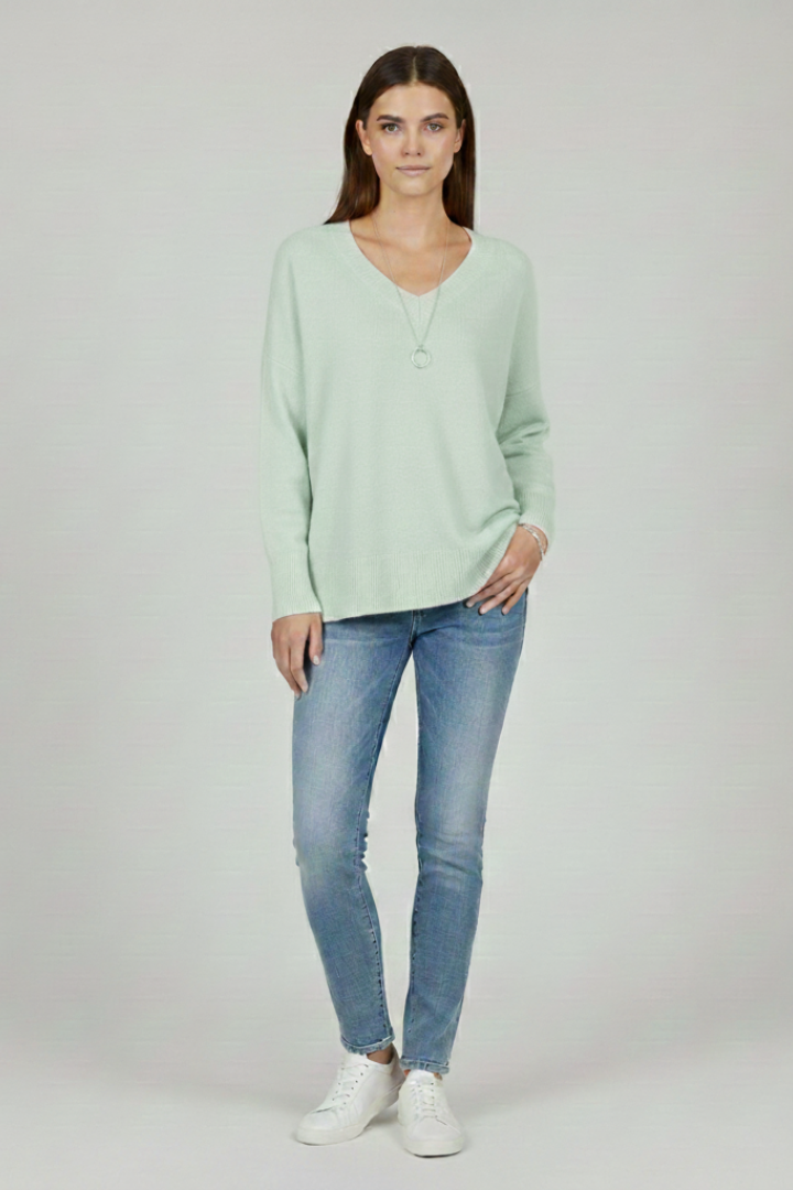 Women's white V-neck jumper with dropped shoulders and a straight hem